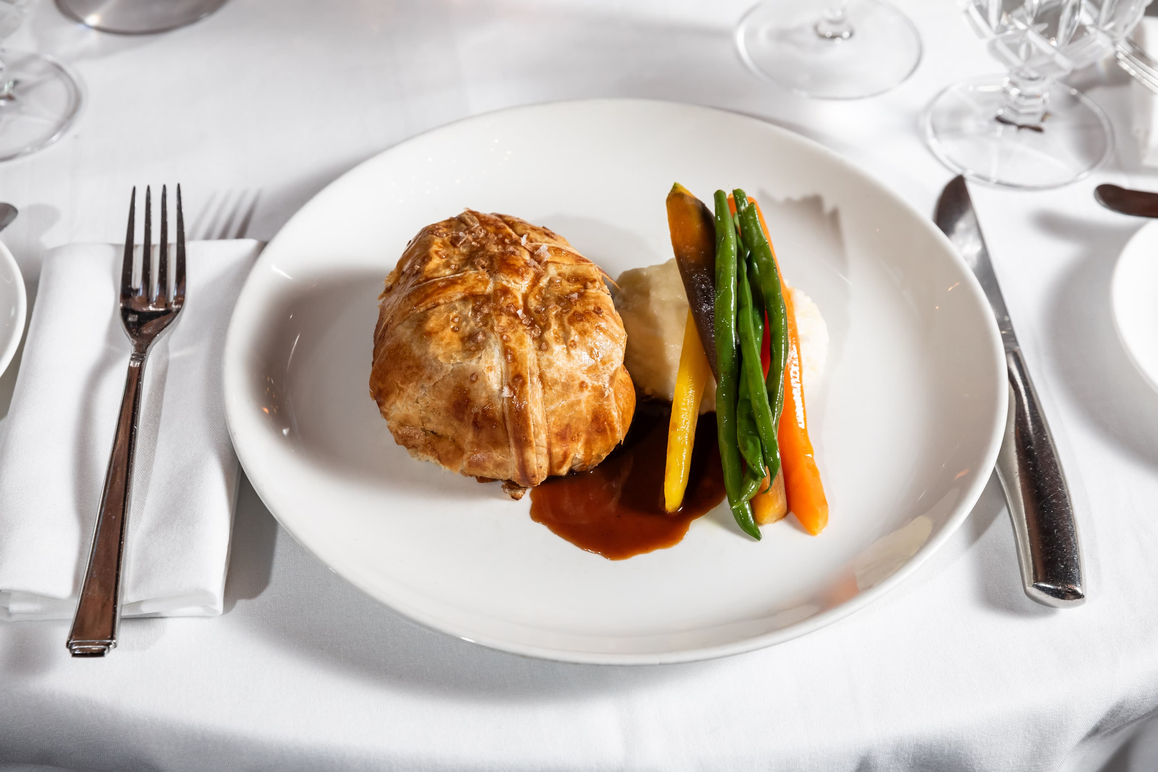 Beef Wellington sliced on a dark plate